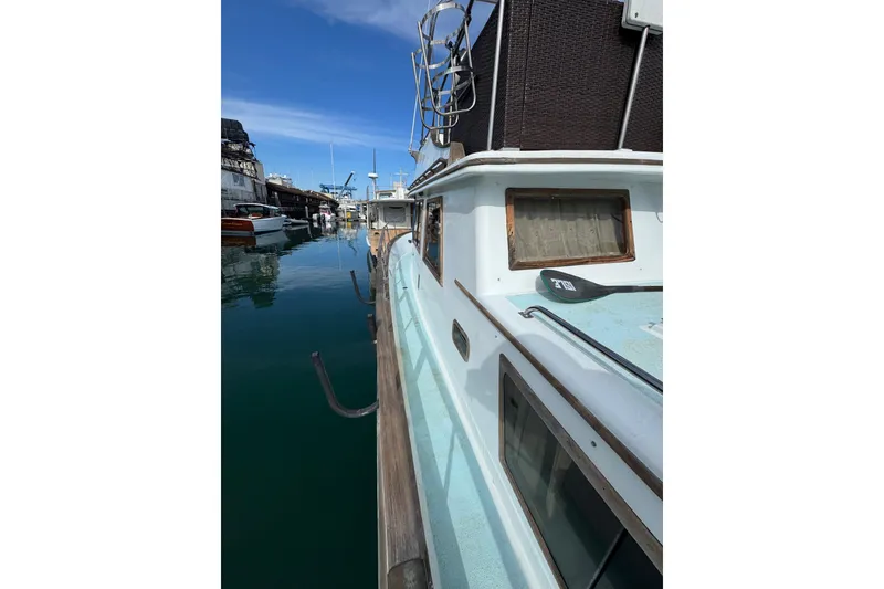 Slide: The Image of 1978 CHB 35 boat docked in a marina, reflecting on calm water. - 5