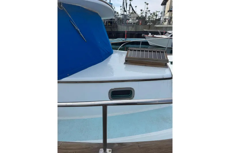 Slide: The Image of 1978 CHB 35 boat with blue cover docked at marina. - 9