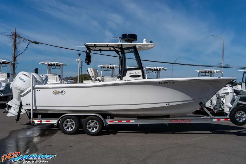 Slide: The Image of 2025 Sea Hunt Gamefish 25 boat on trailer, side view, clear sky background. - 14