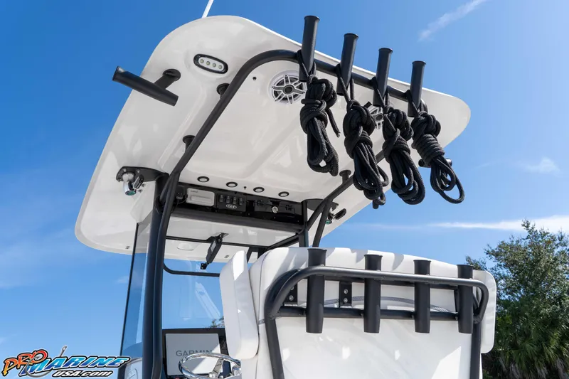 Slide: The Image of 2025 Sea Hunt Gamefish 25 boat with rod holders and ropes under a clear blue sky. - 18