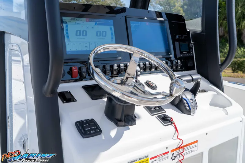Slide: The Image of 2025 Sea Hunt Gamefish 25 boat dashboard with modern controls and navigation screens. - 24