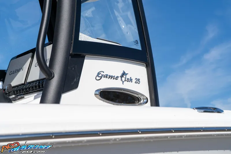 Slide: The Image of 2025 Sea Hunt Gamefish 25 boat with Garmin equipment against blue sky. - 3