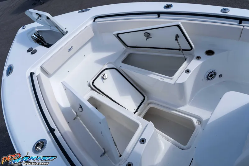 Slide: The Image of 2025 Sea Hunt Gamefish 25 boat with open storage compartments and sleek design. - 30