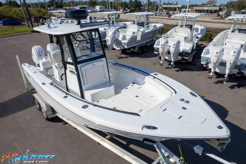 Slide: The Image of 2025 Sea Hunt Gamefish 25 boat displayed at a dealership, featuring sleek design and modern equipment. - 34