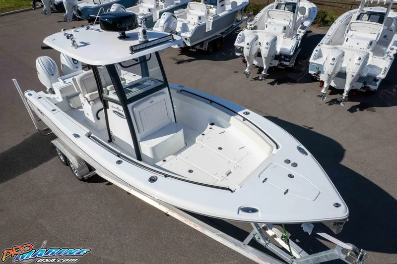 Slide: The Image of 2025 Sea Hunt Gamefish 25 boat on trailer, surrounded by other boats in a lot. - 35