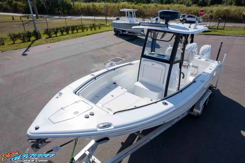 Slide: The Image of 2025 Sea Hunt Gamefish 25 boat on trailer, parked outdoors, showcasing sleek design. - 40