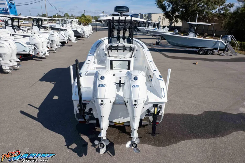Slide: The Image of 2025 Sea Hunt Gamefish 25 with twin Yamaha 200 engines in a boat dealership lot. - 47