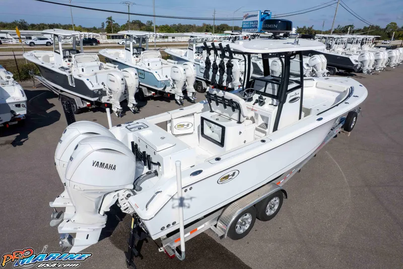 Slide: The Image of 2025 Sea Hunt Gamefish 25 boat with Yamaha engines on display at a dealership. - 49