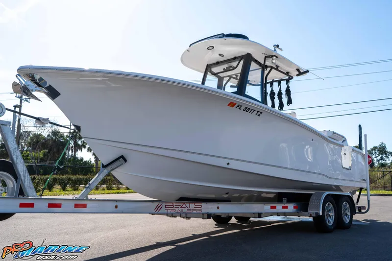 Slide: The Image of 2025 Sea Hunt Gamefish 25 boat on trailer, side view, sunny day. - 5