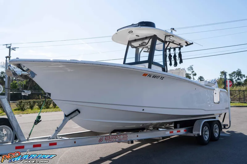 Slide: The Image of 2025 Sea Hunt Gamefish 25 boat on trailer, parked outdoors under clear sky. - 6