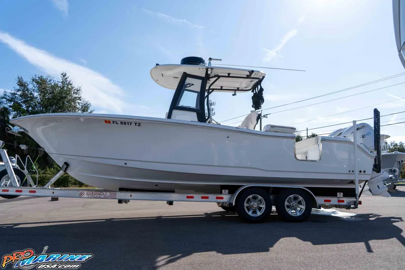Slide: The Image of 2025 Sea Hunt Gamefish 25 boat on trailer under clear sky. - 8