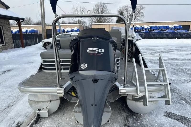 Slide: The Image of 2021 Bennington 23 LSB pontoon boat with powerful 250 horsepower engine, parked on snowy ground. - 11
