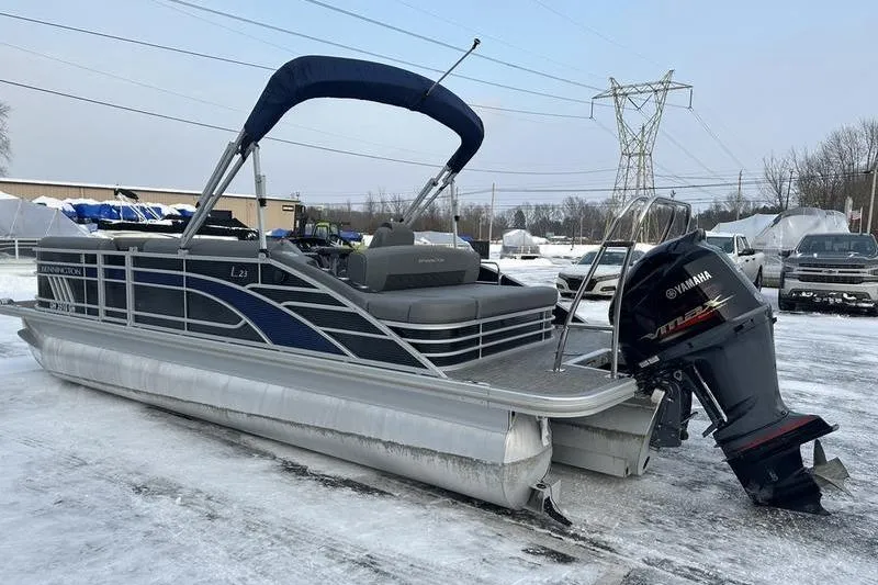 Slide: The Image of 2021 Bennington 23 LSB pontoon boat with Yamaha outboard motor on snowy ground. - 12