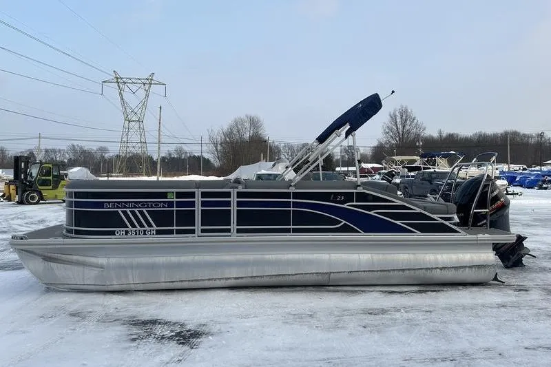 Slide: The Image of 2021 Bennington 23 LSB pontoon boat on snowy ground, side view. - 14