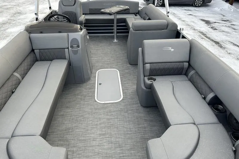 Slide: The Image of 2021 Bennington 23 LSB pontoon boat interior with gray seating and table. - 15
