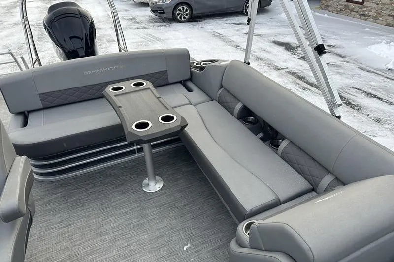 Slide: The Image of 2021 Bennington 23 LSB pontoon boat interior with gray seating and table. - 16