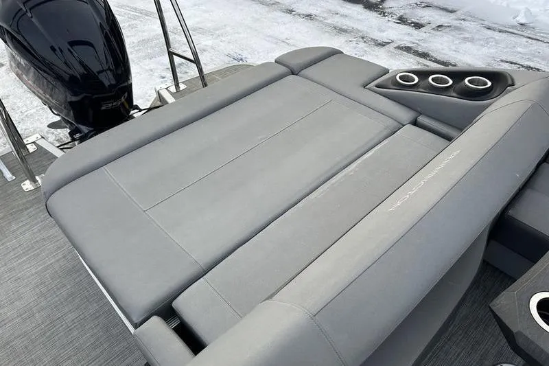 Slide: The Image of 2021 Bennington 23 LSB boat with gray seating and cup holders on deck. - 19