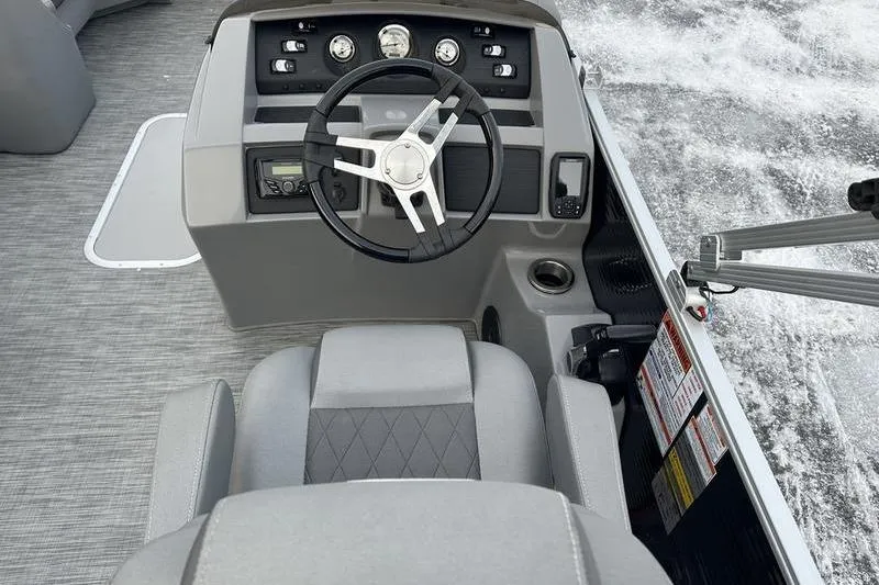 Slide: The Image of 2021 Bennington 23 LSB boat dashboard with steering wheel and controls. - 22