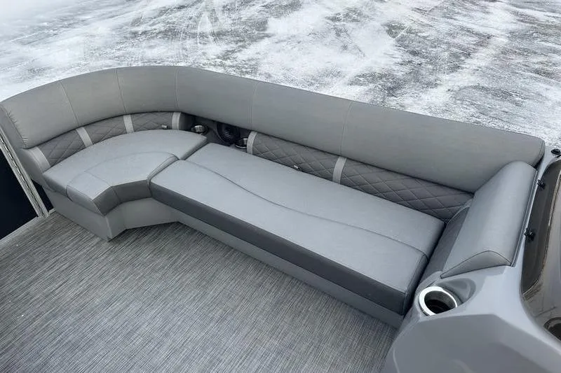 Slide: The Image of 2021 Bennington 23 LSB boat interior with gray seating and cup holder. - 25