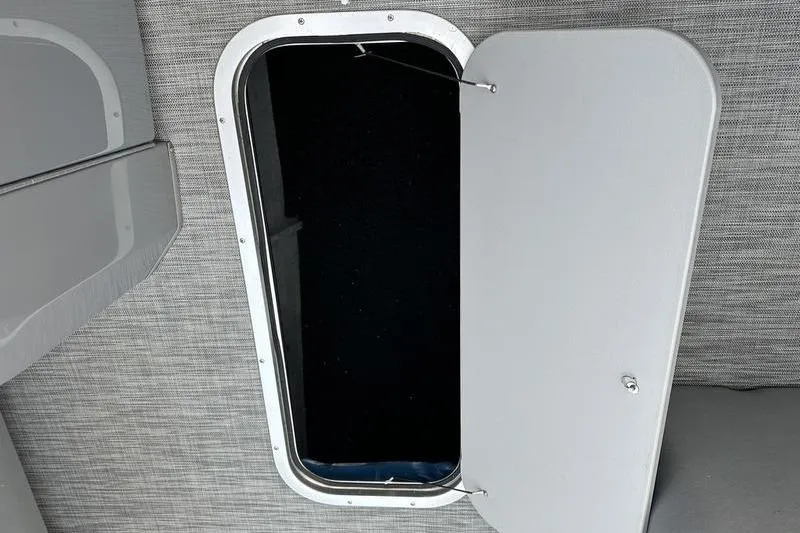 Slide: The Image of Open storage compartment on 2021 Bennington 23 LSB boat, featuring sleek interior design. - 6