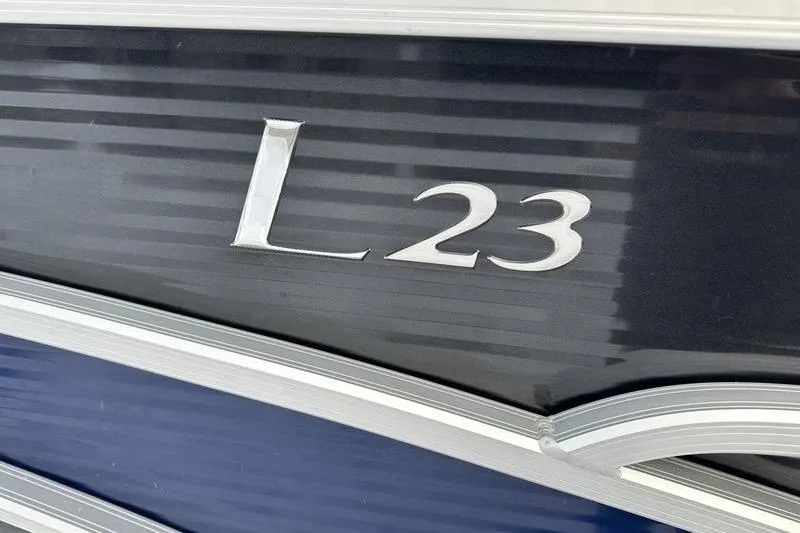 Slide: The Image of 2021 Bennington 23 LSB boat model emblem on dark background. - 8
