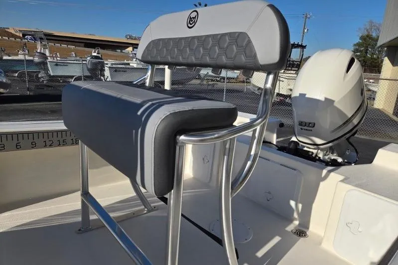 Slide: The Image of 2026 May-Craft 182 Center Console boat with sleek seating and powerful outboard motor. - 13