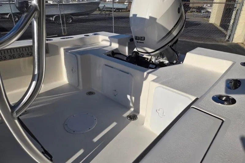 Slide: The Image of 2026 May-Craft 182 Center Console boat with Yamaha outboard motor, docked in a marina. - 14