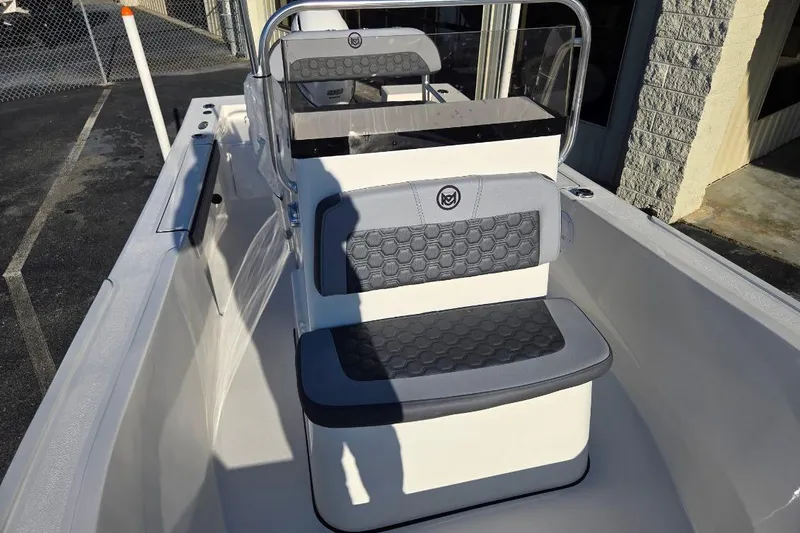 Slide: The Image of 2026 May-Craft 182 Center Console boat interior with cushioned seating and steering console. - 9
