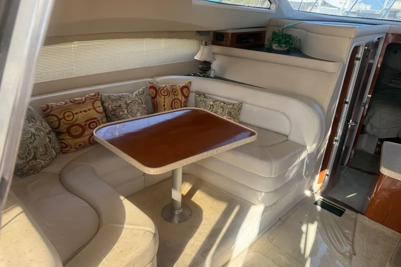 Slide: The Image of Luxurious 2005 Regal Commodore 3880 yacht interior with elegant seating and dining area. - 12