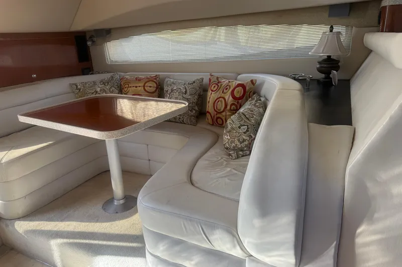 Slide: The Image of Luxurious 2005 Regal Commodore 3880 yacht interior with plush seating and elegant table. - 14