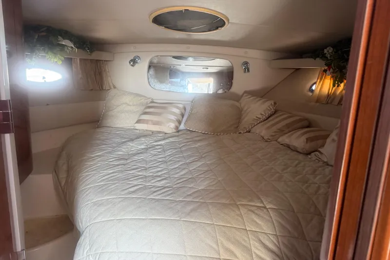 Slide: The Image of Cozy cabin interior of 2005 Regal Commodore 3880 with plush bedding and soft lighting. - 15