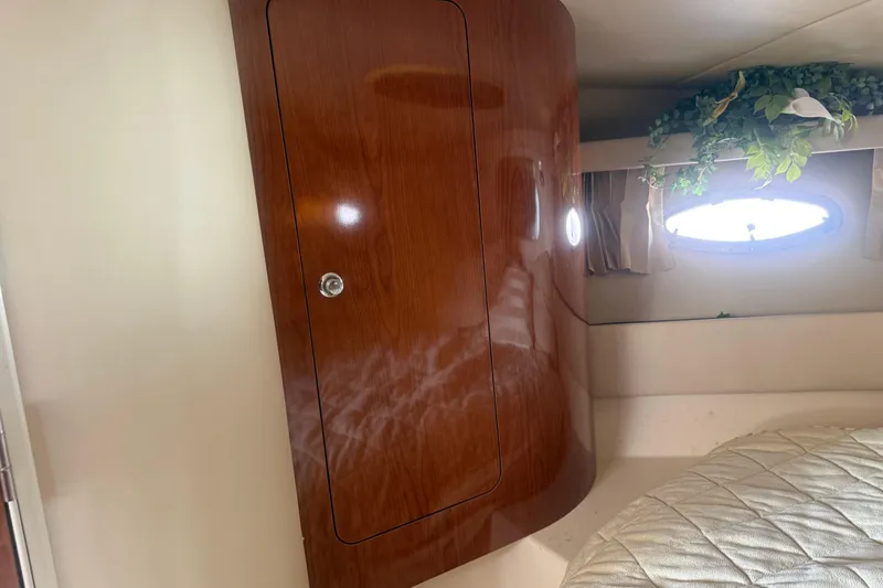 Slide: The Image of Interior of 2005 Regal Commodore 3880 yacht with wooden cabinet and porthole. - 17
