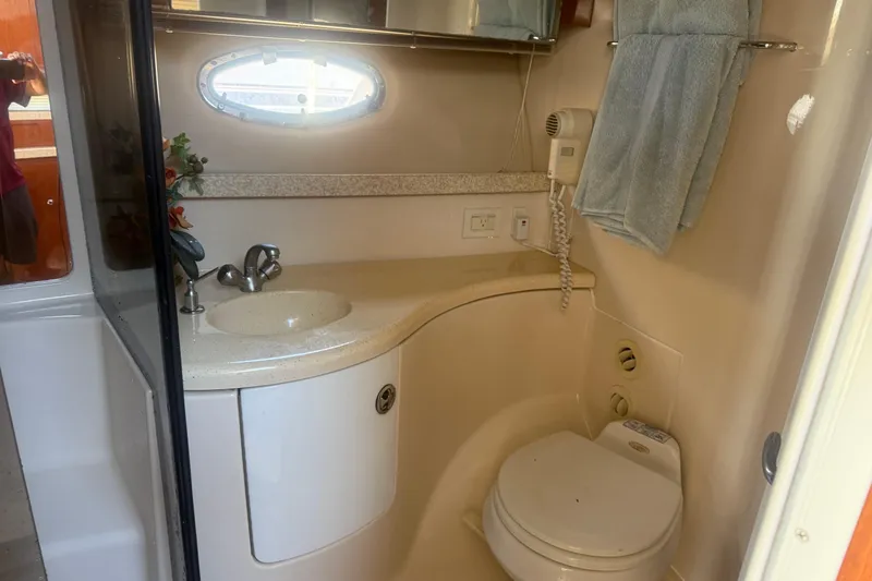 Slide: The Image of 2005 Regal Commodore 3880 yacht bathroom with sink, toilet, and towel rack. - 18