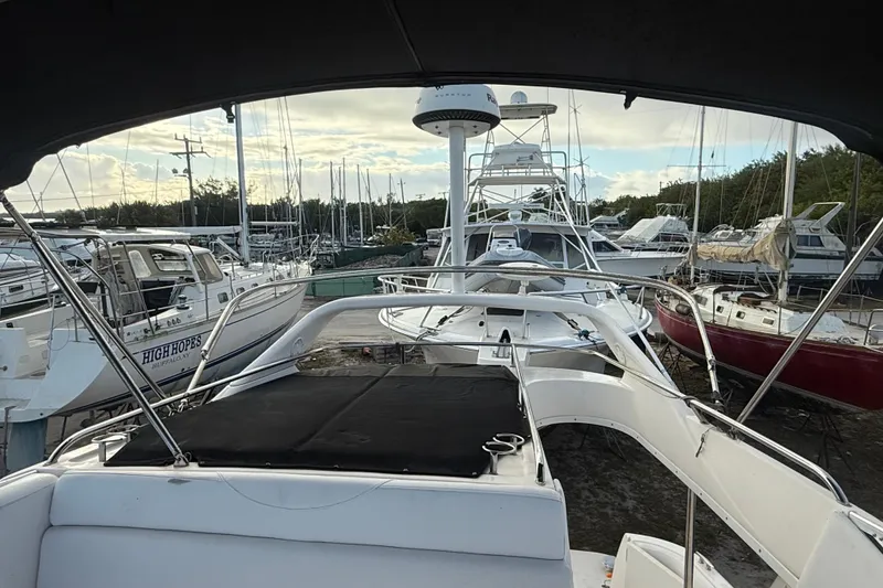 Slide: The Image of 2005 Regal Commodore 3880 yacht docked among other boats at a marina. - 3