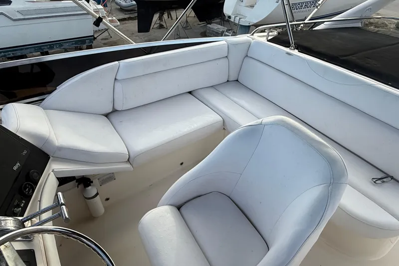 Slide: The Image of 2005 Regal Commodore 3880 boat interior with white seating and steering wheel. - 5