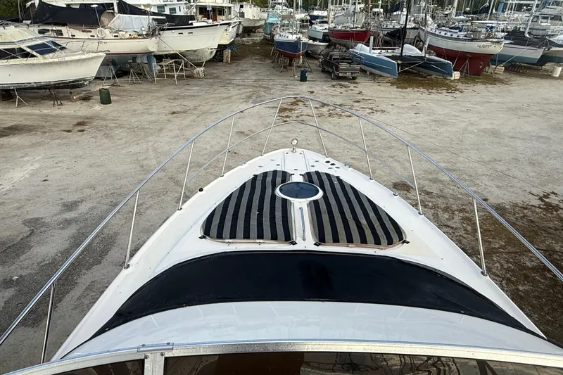Slide: The Image of 2005 Regal Commodore 3880 yacht on dry dock, surrounded by other boats. - 7