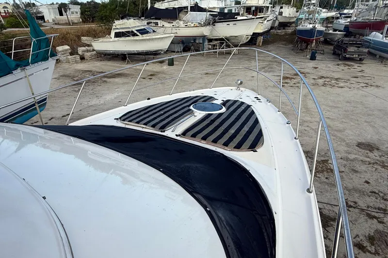 Slide: The Image of 2005 Regal Commodore 3880 yacht on dry dock, surrounded by other boats. - 8