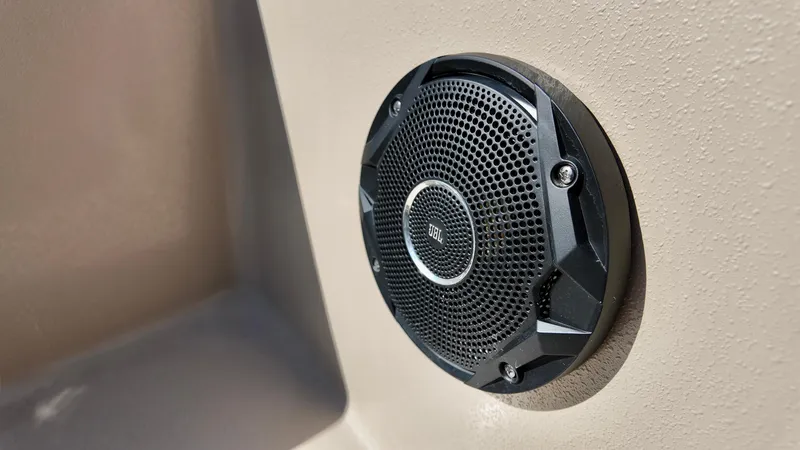 Slide: The Image of Speaker on 2025 Carolina Skiff E18 JVX CC boat, mounted on beige surface. - 10