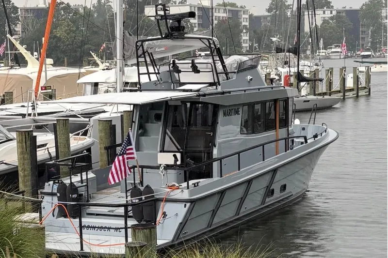 Slide: The Image of 2025 Targa 37 boat docked in a marina, featuring sleek design and modern amenities. - 1