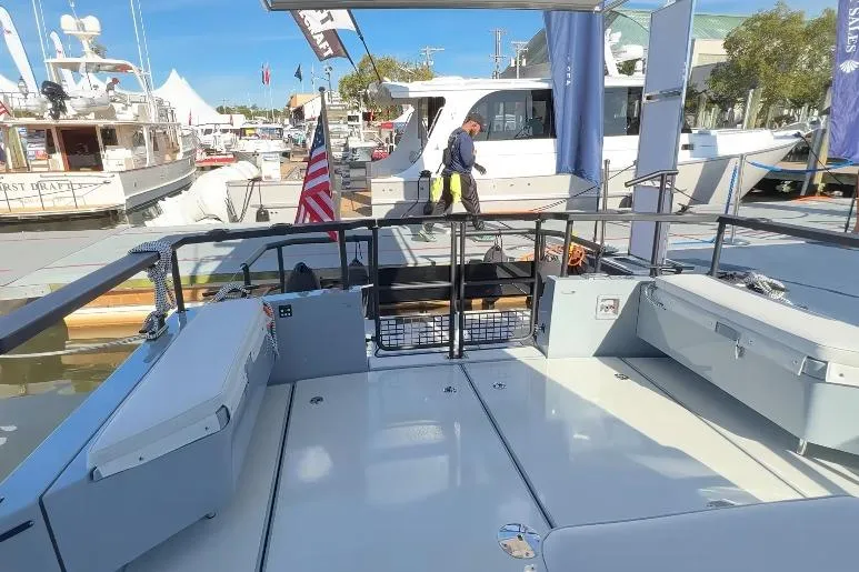 Slide: The Image of 2025 Targa 37 boat deck at marina, featuring sleek design and American flag. - 10