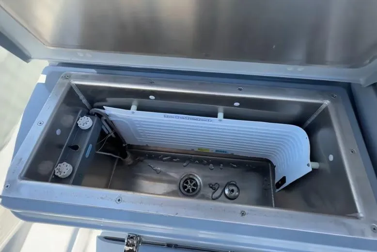 Slide: The Image of Open storage compartment in 2025 Targa 37 boat, featuring stainless steel interior. - 11