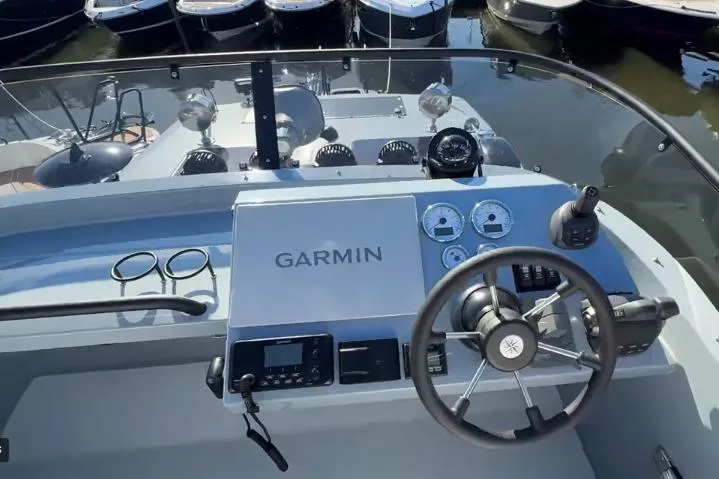 Slide: The Image of 2025 Targa 37 boat dashboard with Garmin navigation system and steering wheel. - 17