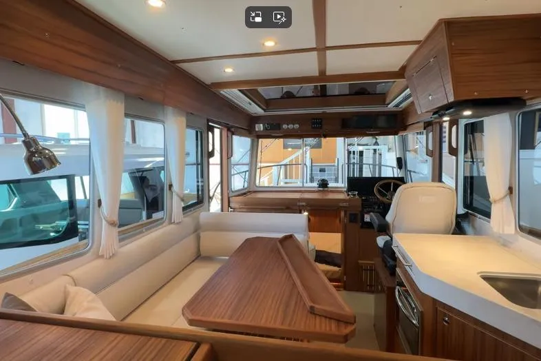 Slide: The Image of Luxurious interior of 2025 Targa 37 boat with modern wood finish and seating area. - 20