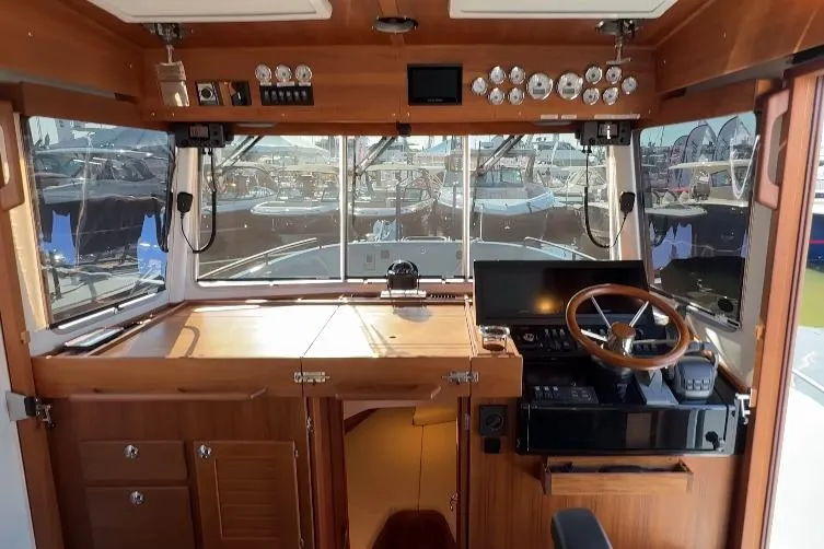 Slide: The Image of Interior view of 2025 Targa 37 boat cockpit with wooden finish and modern controls. - 26