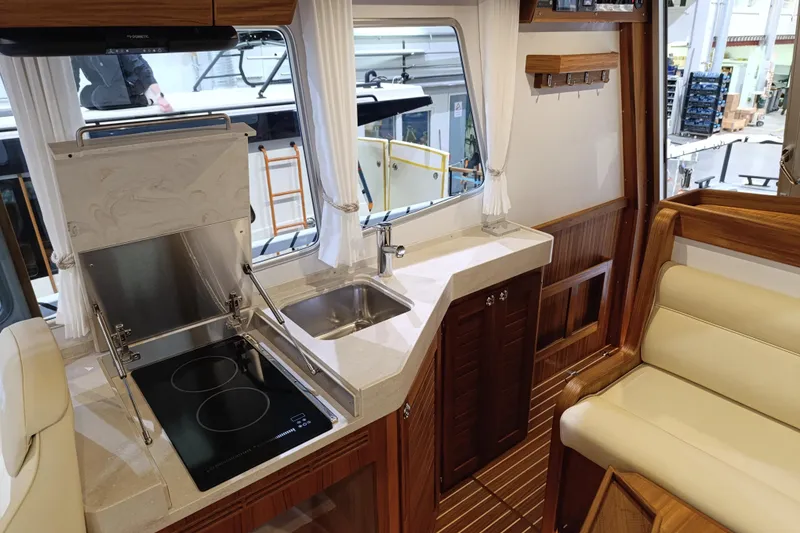 Slide: The Image of Luxurious interior of 2025 Targa 37 boat featuring modern kitchen and seating area. - 29