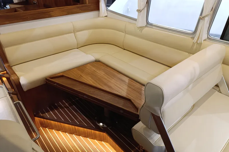 Slide: The Image of Luxurious interior of 2025 Targa 37 yacht with beige leather seating and wooden table. - 32