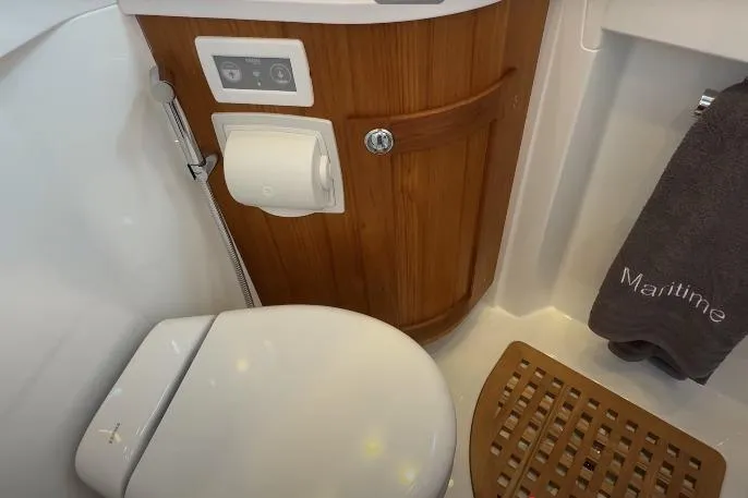 Slide: The Image of 2025 Targa 37 yacht bathroom with wooden cabinet, toilet, and towel. - 35