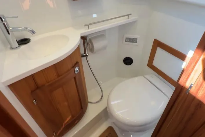 Slide: The Image of 2025 Targa 37 yacht bathroom with modern fixtures and wooden cabinetry. - 37