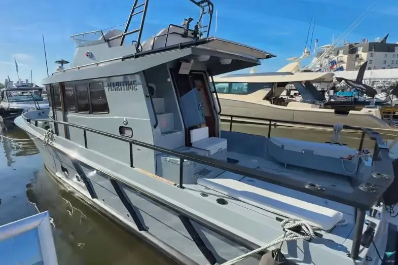 Slide: The Image of 2025 Targa 37 boat docked, showcasing sleek design and spacious deck. - 4