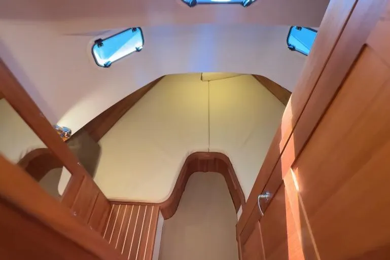Slide: The Image of Interior cabin of 2025 Targa 37 boat with wooden finishes and cozy sleeping area. - 43